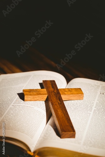 Wooden cross on bible book