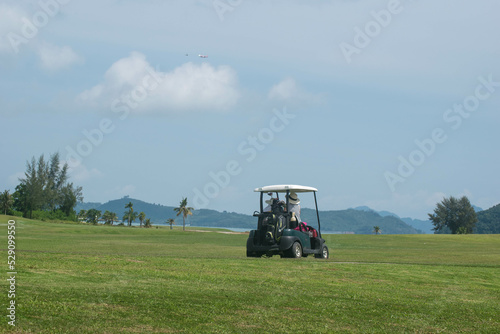 golfer in golf cart on golf course