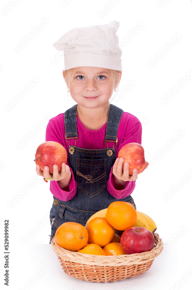 Close-up portrait of a little girl holding fruits - apples, bananas and oranges. Isolated on a light background. Close-up portrait of a little girl holding fruits - apples, bananas and oranges. Isolated on a light background.
