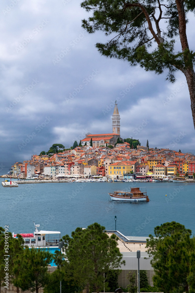 Ferry like boat sails toward Old Town Rovinj in Croatia