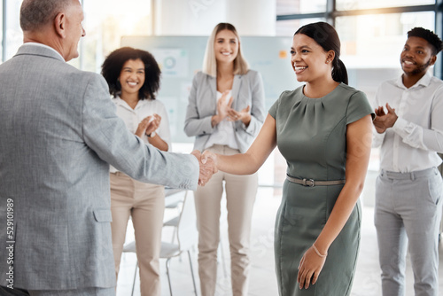 Happy handshake, by man and woman in office, for promotion in business, team gives applause. Meeting with diversity in people celebrate workers progress to new role in corporate marketing job.