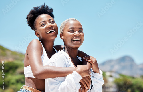 Smile, love and gay or lesbian with black couple women bonding at beach or sea in summer. Freedom, happy and LGBT portrait of fun friends or girlfriend on holiday, vacation or honeymoon by the coast
