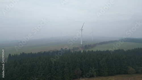 Morning fog over a wind farm in the mountains. Largest wind power plant in the Czech Republic. Krystofovy Hamry photo