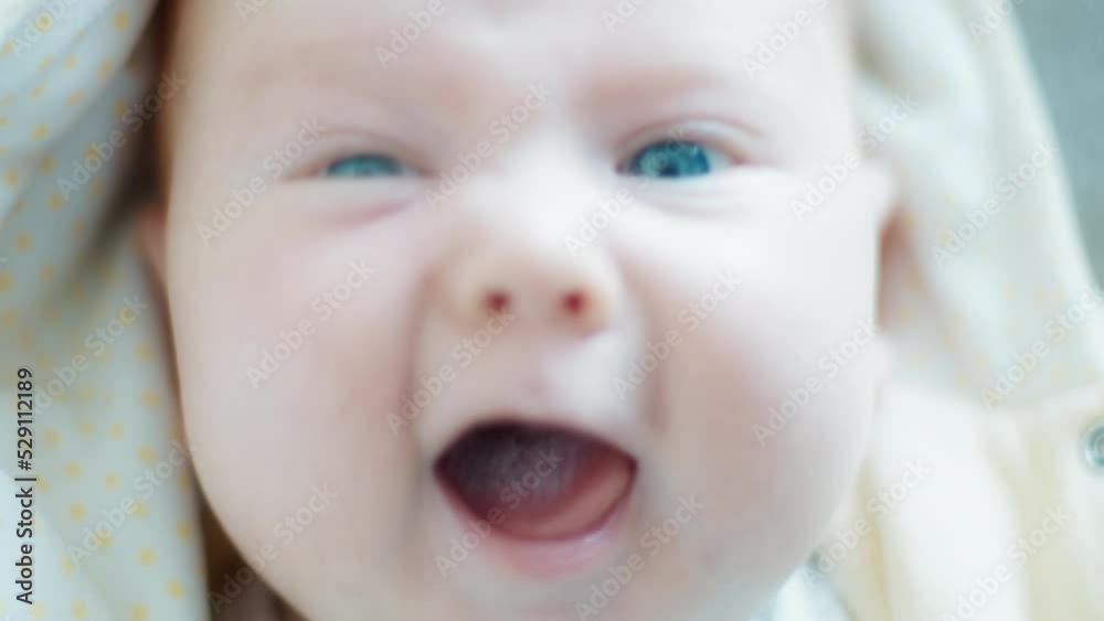 Portrait of the infant baby with blue eyes looking into the camera Portrait of the infant baby with blue eyes looking into the camera
