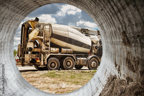 Concrete mixer truck in front of a concrete batching plant, cement factory. Loading concrete mixer truck. Close-up. Delivery of concrete to the construction site. Monolithic concrete works.