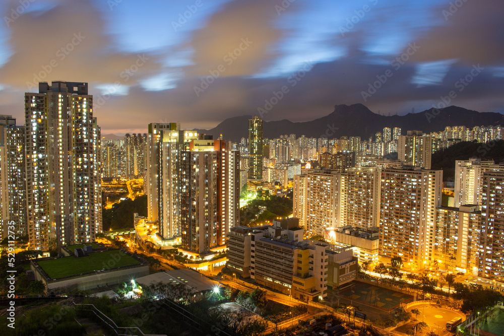 Fototapeta premium Night view at Ping Shan in Kowloon Bay, Hong Kong. Looking to the Lion Rock - famous landmark of Hong Kong. Long Exposure
