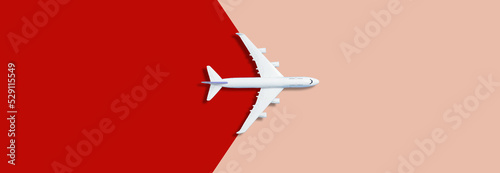 Flat lay design of travel concept with plane on pink red runway back