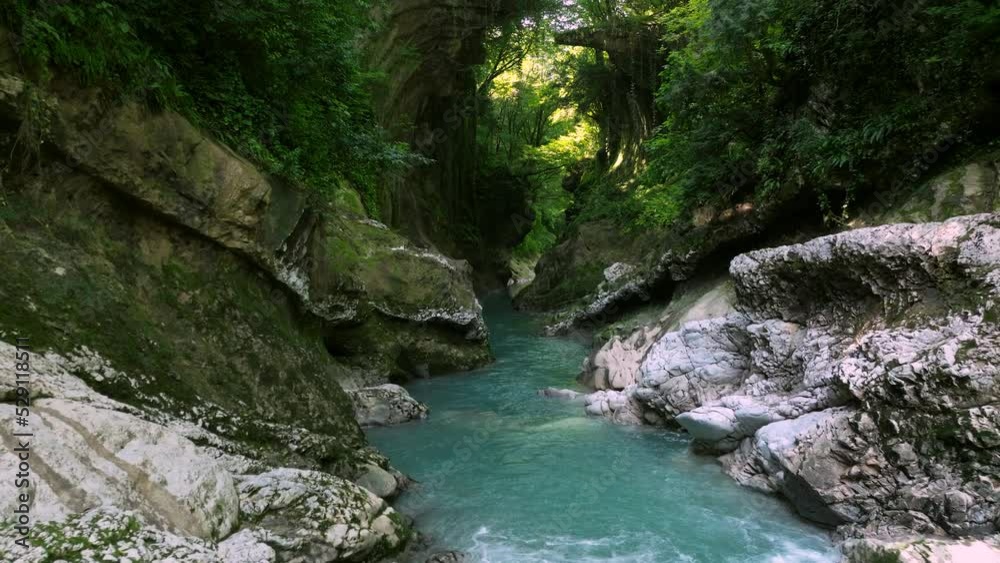 Flying Through Abasha River Flowing Between Mossy Rocks In Martvili Canyon, Georgia. Aerial Shot Flying Through Abasha River Flowing Between Mossy Rocks In Martvili Canyon, Georgia. Aerial Shot
