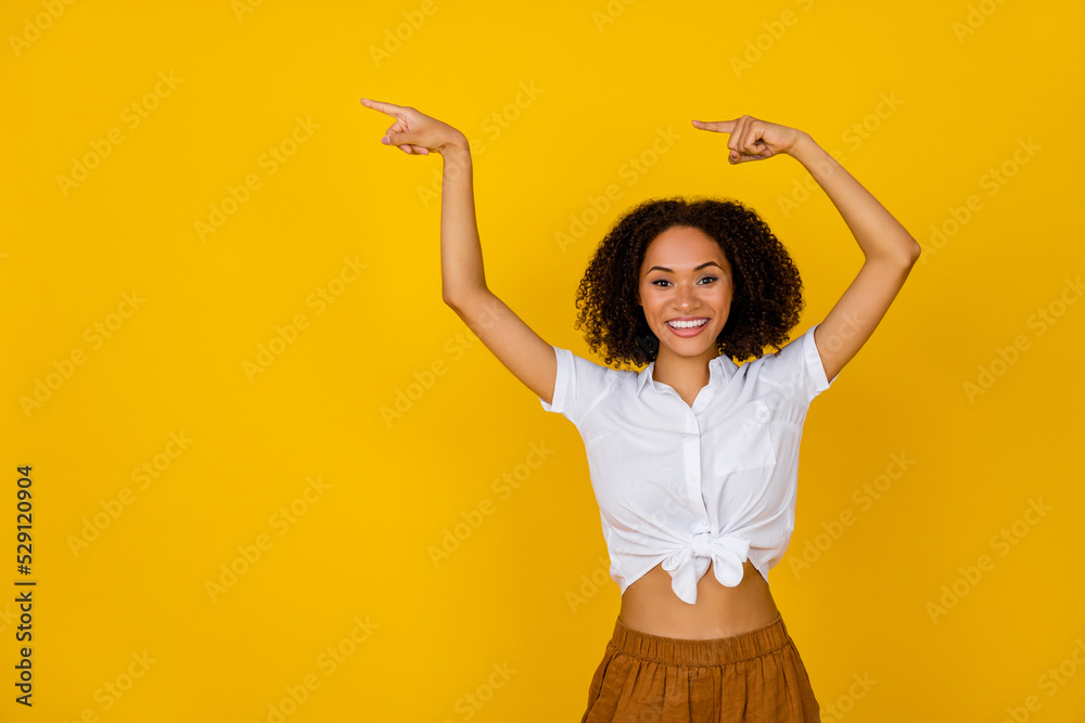 Photo of funny curly hairdo millennial lady index promo wear white top isolated on yellow color background Photo of funny curly hairdo millennial lady index promo wear white top isolated on yellow color background