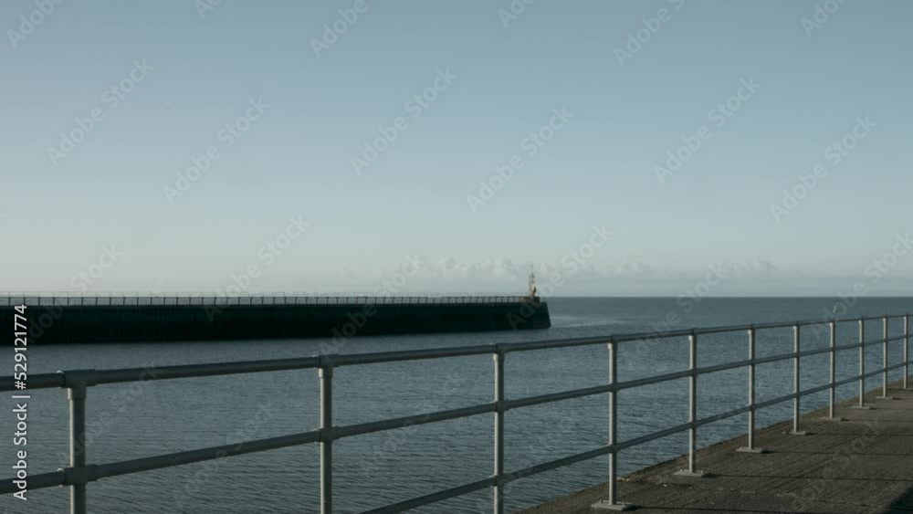 Swansea Bay Panning Shot of West Pier Out to Sea in Early Morning Light Sunrise 4K