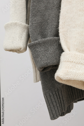 Hanging sweaters, concept of autumn season clothes