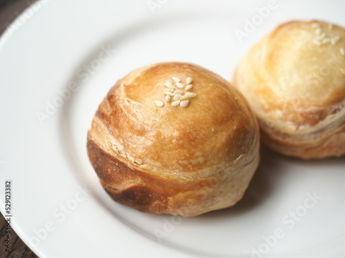 Chinese sweet flaky puff pastry with mung bean paste filling on white plate