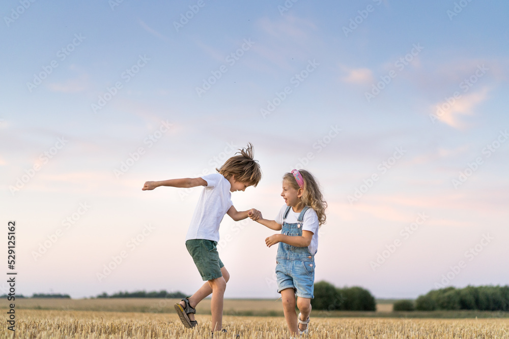 Happy and free people, children run through the beveled field of wheat Happy and free people, children run through the beveled field of wheat