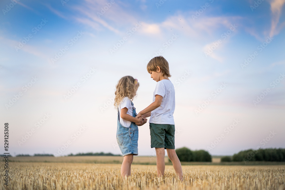 Happy and free people, children run through the beveled field of wheat Happy and free people, children run through the beveled field of wheat