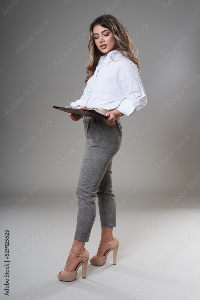 Young businesswoman with documents on gray Young businesswoman with documents on gray
