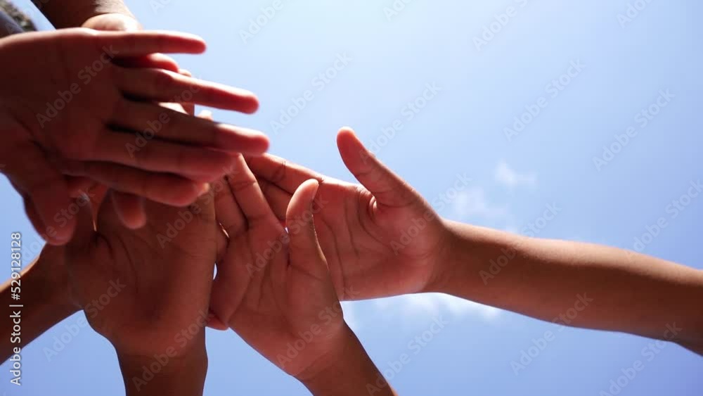 Children's hands are raised together, unity building, helping each other, competition