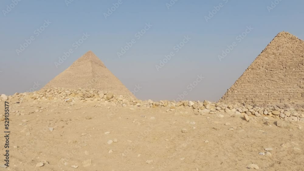 Panning shot of the Giza pyramid complex under clear skies in middle Egypt Panning shot of the Giza pyramid complex under clear skies in middle Egypt