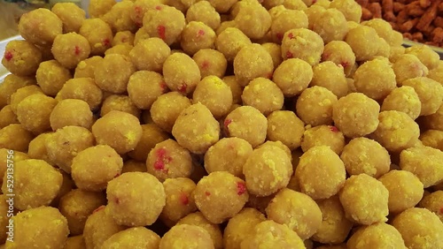 Indian sweet motichoor laddoo or Bundi laddu is made of gram flour very small balls or boondis which are deeply fried and soaked in sugar syrup before making balls photo