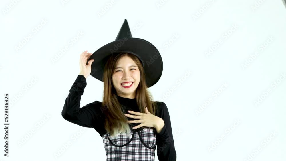 Halloween theme asian woman in black dress and witch hat posing smiling moving on white background video 4K. Halloween theme asian woman in black dress and witch hat posing smiling moving on white background video 4K.