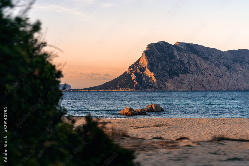 Ausblick auf die Insel Tavolara vom Strand an der Nordost-Küste auf Sardinien Italien bei Sonnenuntergang