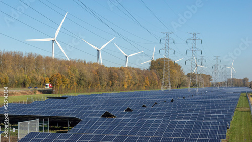 Wind mills, solar panels and power lines captured in one image.