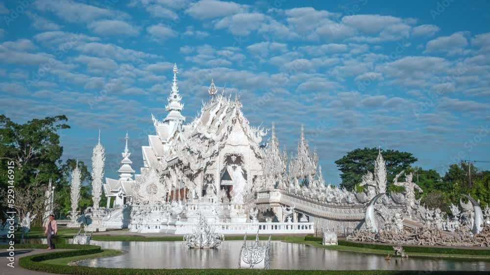 Time lapse view of tourists visiting the famous Wat Rong Khun, popularly known as the White Temple, in Chiang Rai, Thailand, zoom out. 