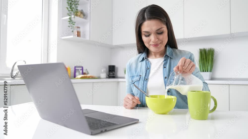 Lady prepare health breakfast pour yoghurt in oatmeal modern apartment Lady prepare health breakfast pour yoghurt in oatmeal modern apartment