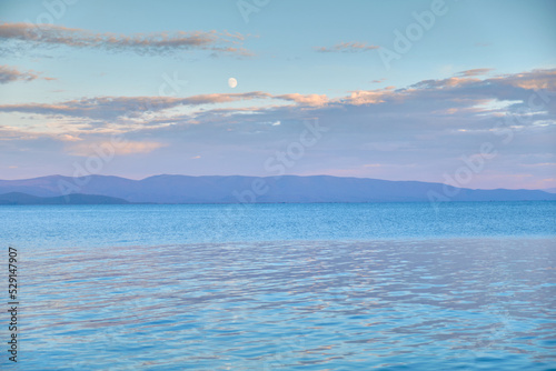Chivyrkuysky Bay of Lake Baikal in the Buryat Republic in the evening during sunset.