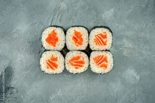 Maki sushi roll with salmon on a gray background. Selective Focus. Sushi Menu
