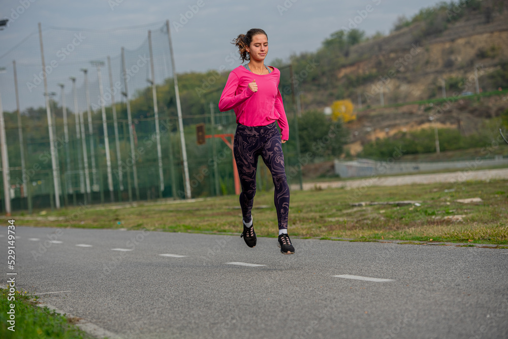 She is running to warm up her body in the morning She is running to warm up her body in the morning