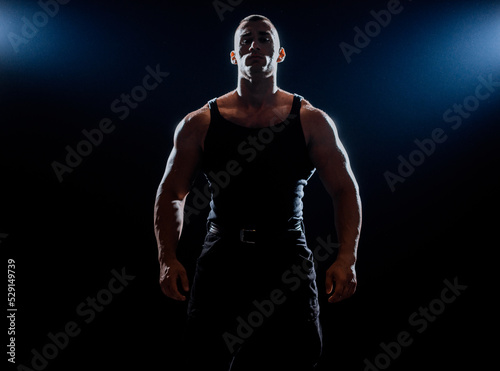 Handsome man with big muscles, posing at the camera