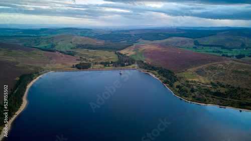 Aerial view of a water reservoir at dusk, with a colourful sky.