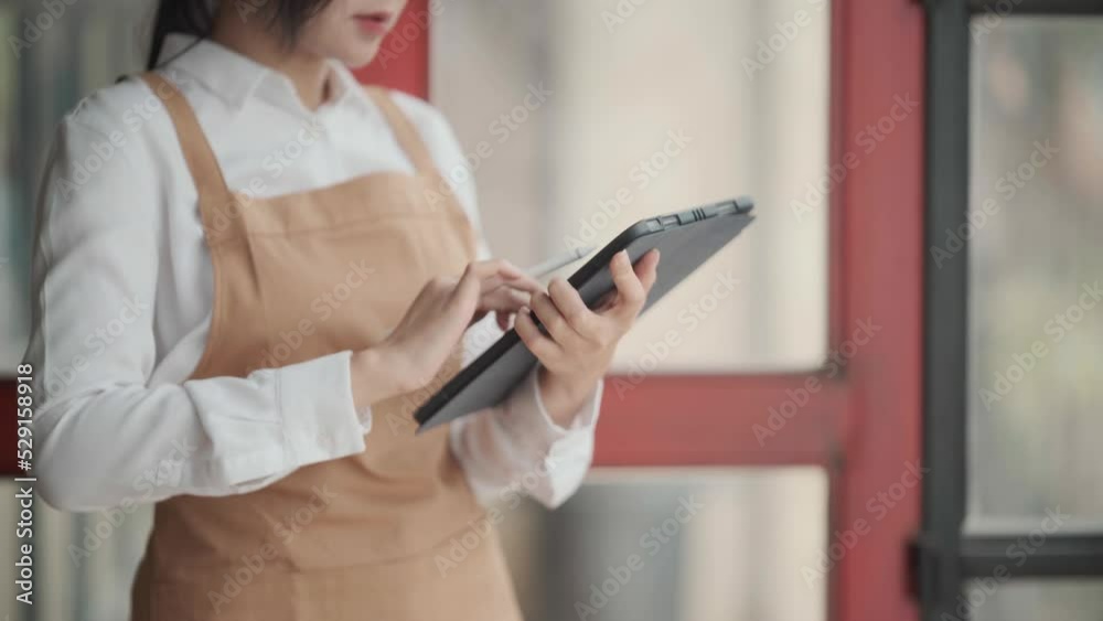 Startup successful small business owner sme beauty girl stand with tablet smartphone in coffee shop restaurant. Portrait of asian woman barista cafe owner. SME entrepreneur seller business concept. Startup successful small business owner sme beauty girl stand with tablet smartphone in coffee shop restaurant. Portrait of asian woman barista cafe owner. SME entrepreneur seller business concept.