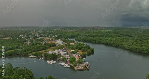 Pedregal Panama Aerial v2 pan shot capturing landscape of platanal river and port town with dark clouds in the sky and storm approaching during raining season - Shot with Mavic 3 Cine - April 2022 photo