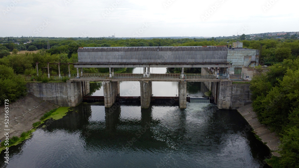 View of a dam on a small river. View of a dam on a small river.