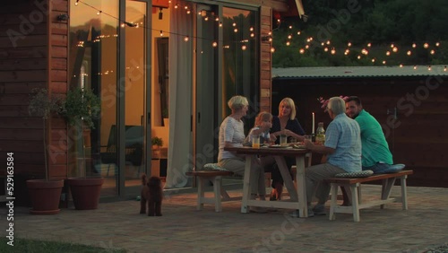 Three generations family family during dinner in the backyard
