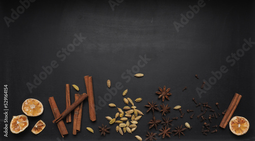 Different Christmas spices on a dark table, seasonal food or ingredients, Christmas spices, space for text or image