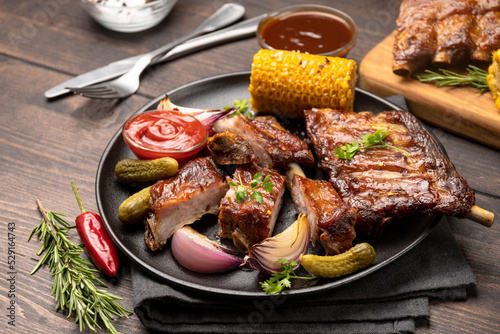 Grilled ribs with barbecue sauce and ketchup and grilled vegetables 