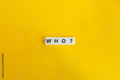 Who Question and Word on Block Letter Tiles on Yellow Background. Minimal Aesthetics. photo
