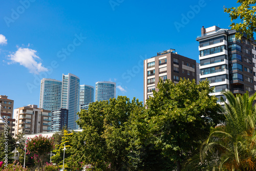 Cityscape from a park. Modern buildings and parks in the city. © senerdagasan