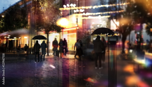 city night light view from windows glass on street , people walk with umbrella cold rainy season Autumn background urban scene