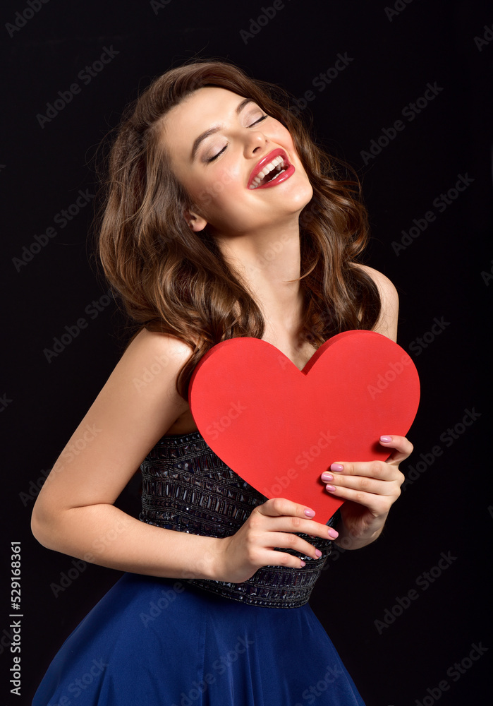 Beauty Young model Girl with Valentine Heart in her hand. Love Concept. Valentines Day gift. Beauty Young model Girl with Valentine Heart in her hand. Love Concept. Valentines Day gift.