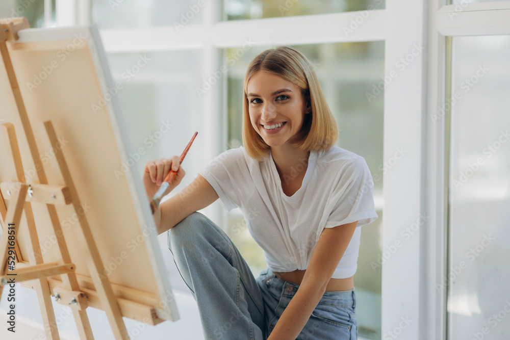 Beautiful artist in her studio. Happy girl likes to draw Beautiful artist in her studio. Happy girl likes to draw