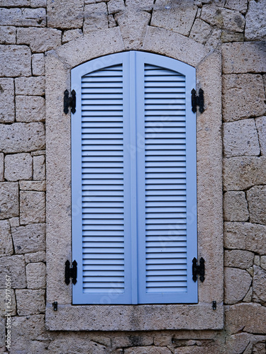 old blue window on stone-wall