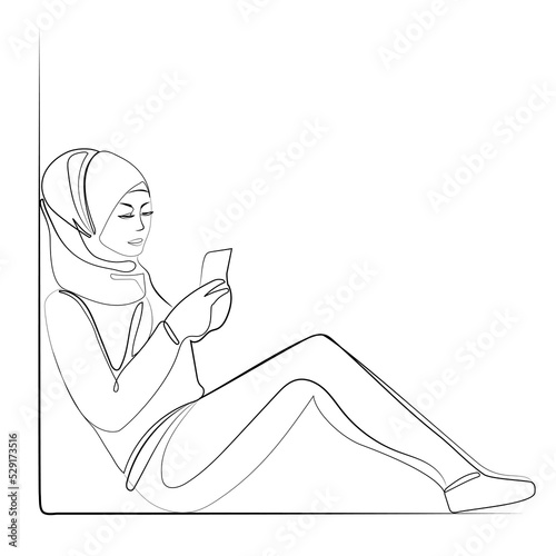 Muslim woman in hijab uses smartphone line art drawing,vector illustration.Young modern muslim woman looks into her smartphone phone while sitting on the floor continuous line drawing.Minimal design