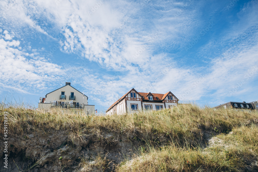 House between the dunes on a North Sea island. Vacation in Germany. Hotel in the country House between the dunes on a North Sea island. Vacation in Germany. Hotel in the country