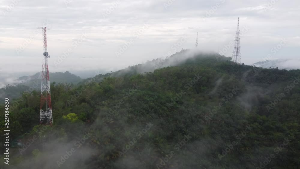 Aerial view morning mist cloud at three telecommunication tower