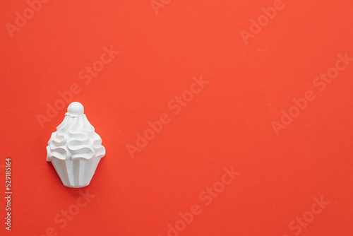 A plaster figure of a cake on a colored background