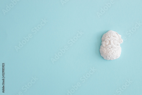 Plaster figure of Santa Claus on a colored background