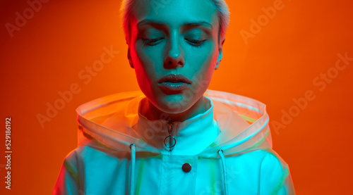 Calm futuristic model under neon illumination
